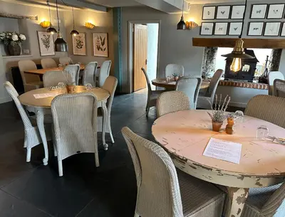 a restaurant with tables and chairs in a room at St Tudy Inn in Bodmin