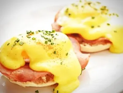 two fried eggs with ham and cheese on a plate at St Tudy Inn in Bodmin