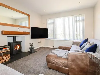 a living room with a couch and a fire place at Seawynds in Newquay