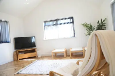 a living room with a tv and a couch at Mortham in St Merryn