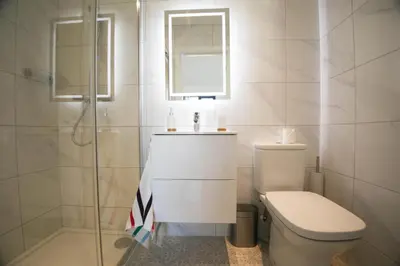 a bathroom with a toilet and a sink and a shower at Mortham in St Merryn