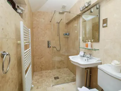 a bathroom with a shower and a sink at 4 Trenhaile Terrace in Truro