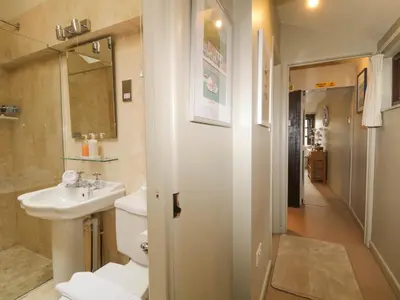 a bathroom with a toilet and a sink at 4 Trenhaile Terrace in Truro