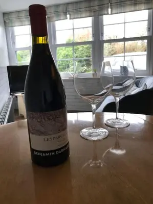 a bottle of wine and two wine glasses on a table at The Bolt Hole - Looe. in Looe