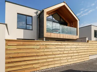 a house with a wooden fence at Porth Cove in Newquay