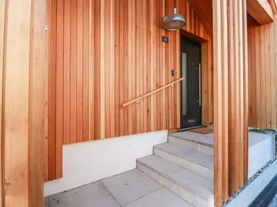 a wooden house with stairs leading to a door at Porth Cove in Newquay