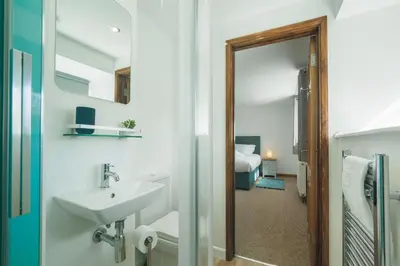 a bathroom with a sink and a mirror at Kerensa in Mawnan