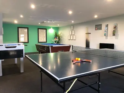 a ping pong room with a ping pong table at Kerensa in Mawnan