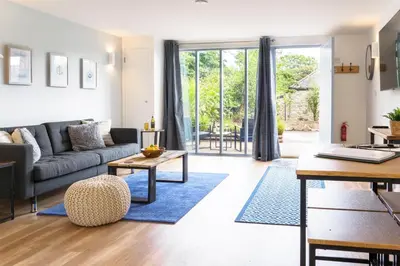 a living room with a couch and a table at Helford in Mawnan