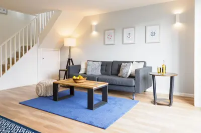 a living room with a couch and a table at Helford in Mawnan