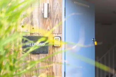 a sign on a wooden door with the word herford on it at Helford in Mawnan