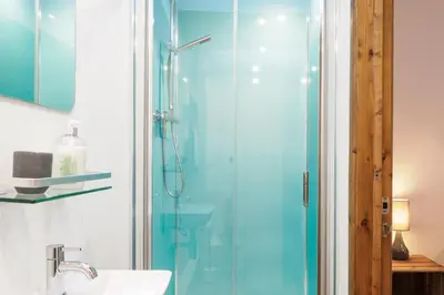 a bathroom with a shower and a sink at Manacles in Mawnan