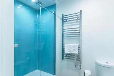a bathroom with a glass shower and a toilet at Mousehole in Mawnan