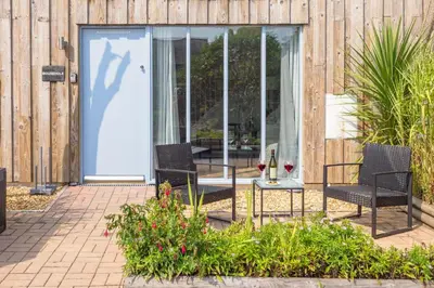 two chairs and a table in front of a door at Mousehole in Mawnan