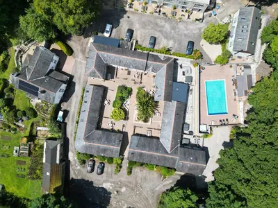 an overhead view of a mansion with a swimming pool at Pendeen in Falmouth