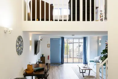 an open living room with a staircase and a living room at Sennen in Budock Water