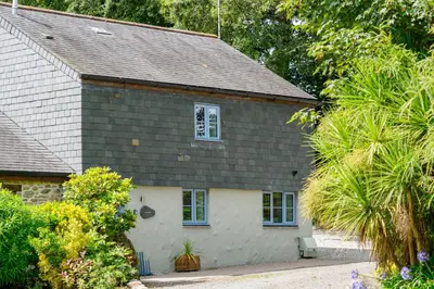 a house with a shingled roof and a window at St Keverne in Budock Water