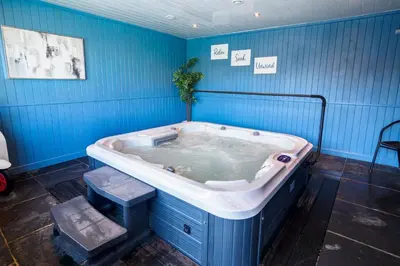 a jacuzzi tub in a blue room at St Keverne in Budock Water