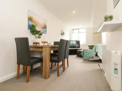 a dining room with a table and chairs at Lighthouse Lofts - St Anthony in Camborne