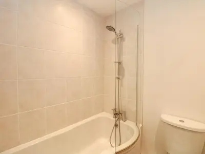 a bathroom with a shower and a toilet and a tub at Lighthouse Lofts - St Anthony in Camborne