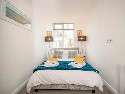 a bedroom with a bed with two pillows on it at Lighthouse Lofts - St Anthony in Camborne