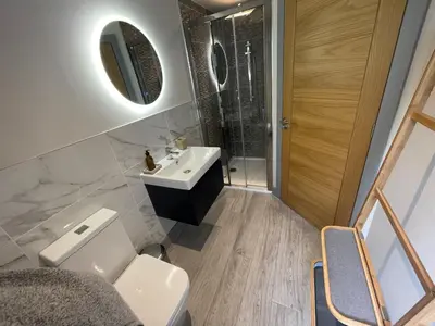a bathroom with a sink and a toilet at Avalennek in Newquay