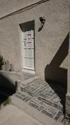 a white door on a building with a stairs at Surf Lookout - King size en-suite with sea views in Newquay
