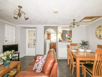 a living room with a couch and a table at The Retreat in Liskeard