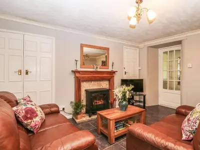 a living room with a couch and a fireplace at The Retreat in Liskeard