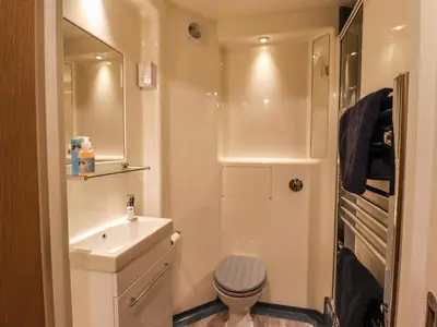 a small bathroom with a toilet and a sink at Azure in St Ives