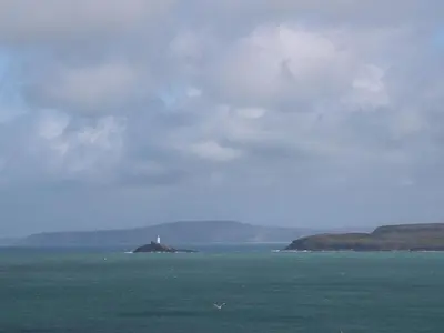 a lighthouse on an island in the middle of the ocean at Azure in St Ives