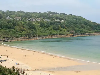 a group of people on a beach near the water at Azure in St Ives