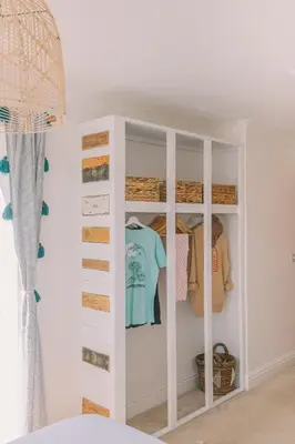 a white closet with a blue shirt in it at Pentire Point - Fully Equipped Eco Escape in Crantock