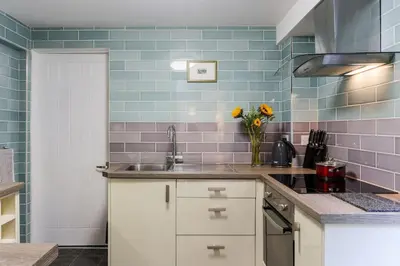 a kitchen with a sink and a vase of flowers at Truro apartment in a stunning quiet location in Truro