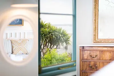 a room with a mirror and a dresser at Secret Cottage in St Ives