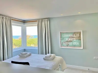 a bedroom with a bed with two towels on it at The Old Coastguard Lookout in Port Isaac