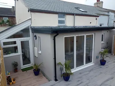 an extension to a house with sliding glass doors at Sam's retreat in Hayle
