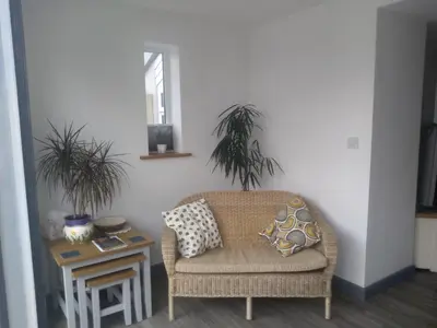 a living room with a chair and a table at Sam's retreat in Hayle