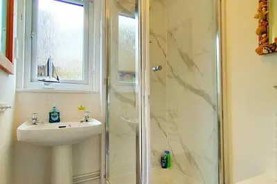 a bathroom with a sink and a shower at Trevithick Cottage Sleeps 6 Dog Friendly Parking in Hayle