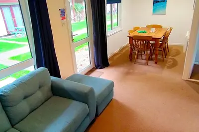 a living room with a couch and a dining room table at Trevithick Cottage Sleeps 6 Dog Friendly Parking in Hayle