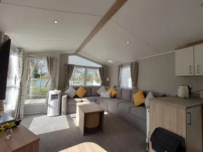 a living room with a couch and a table at White Acre's Holiday Park, 602 Sycamore Forest in Saint Enoder