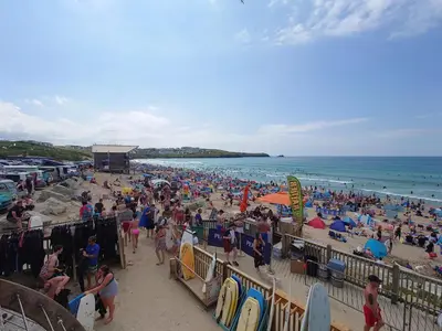 a large crowd of people on a beach at White Acre's Holiday Park, 602 Sycamore Forest in Saint Enoder
