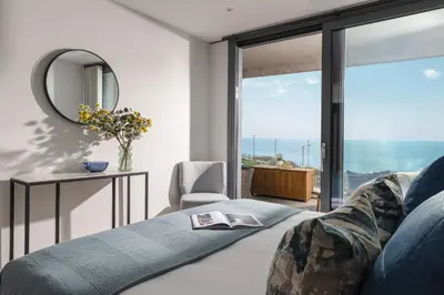 a bedroom with a bed and a mirror at St Michaels The Liner in Falmouth