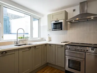 a kitchen with a sink and a stove at Lamorna in Port Isaac