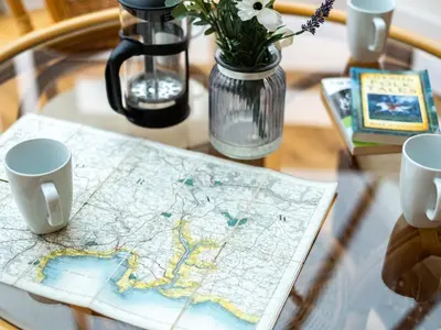 a table with a map and two cups on it at Lamorna in Port Isaac