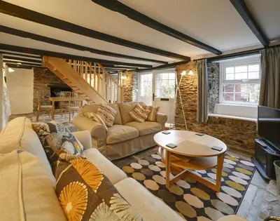 a living room with a couch and a table at Dane Cottage in Port Isaac