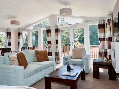 a living room with two couches and a table at 23 Bossiney Bay in Tintagel