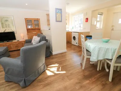 a living room with a couch and a table at Blackbird Cottage in Falmouth