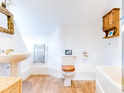 a bathroom with a toilet and a sink at Temple Cottage in Port Isaac