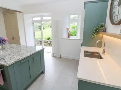 a kitchen with a sink and a counter top at Penmarth House in Helston